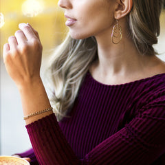 Gold Plated 5mm Gold Cuban Link Bracelet worn by a woman as her bracelet